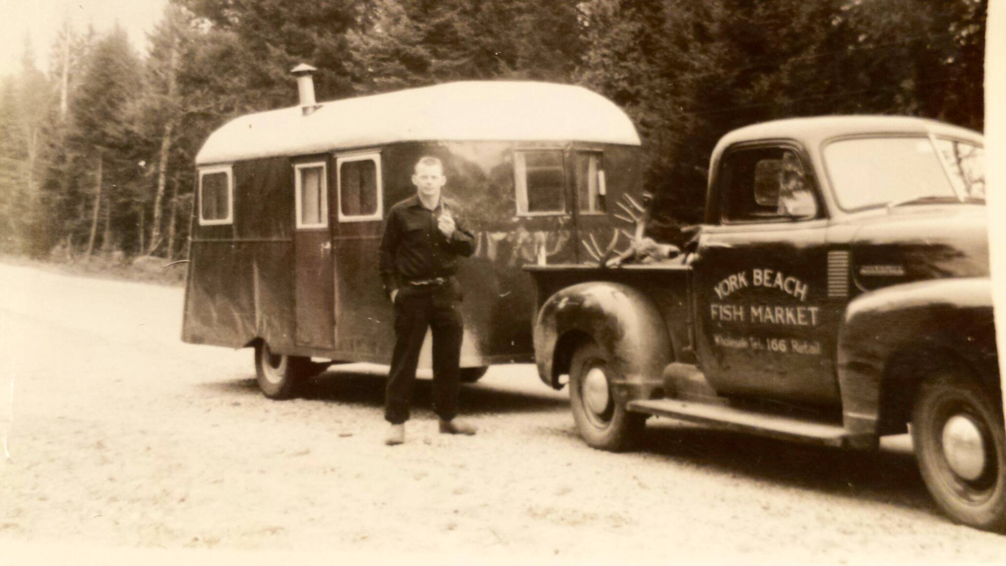 Jakey Weare standing next to York Beach Fish Market truck and trailer. Location unknown. 